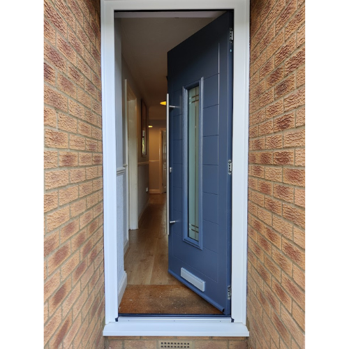 Dark blue, grey composite door that is slightly open with a white door frame