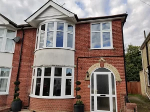 Two circular bay windows fitted on the ground and first floor of a house.